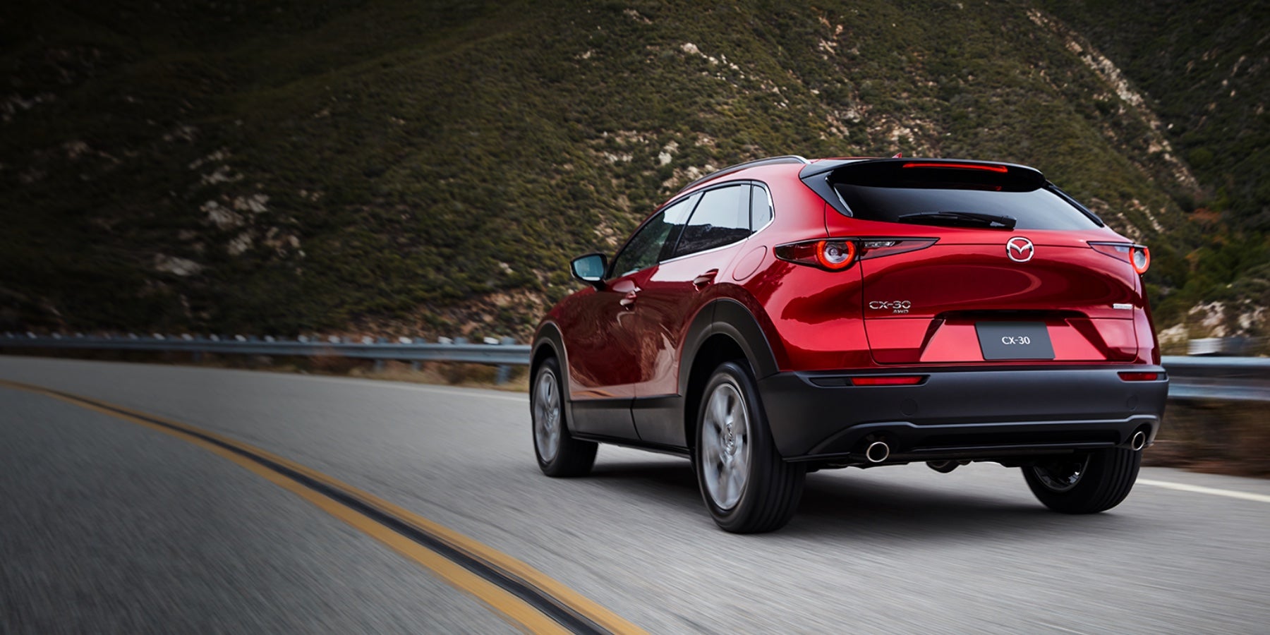 Red 2020 Mazda CX-30 Driving on the road | Bommarito Mazda South County in St. Louis, MO