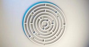 An image of a white maze/ labyrinth with a blue shadow on the top left side. 