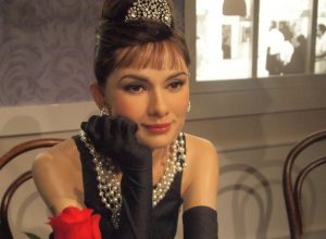 A wax figure of Audrey Hepburn at the scene from Breakfast at Tiffany's at a museum.