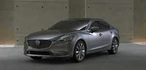A silver 2020 Mazda6 parked in a spacious, industrial storage facility. | Mazda dealer in St. Louis, MO