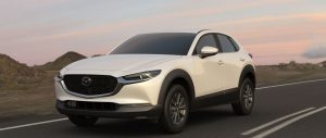 A white 2021 Mazda CX-30 parked on the road in a deserted area. | Mazda dealer in St. Louis, MO